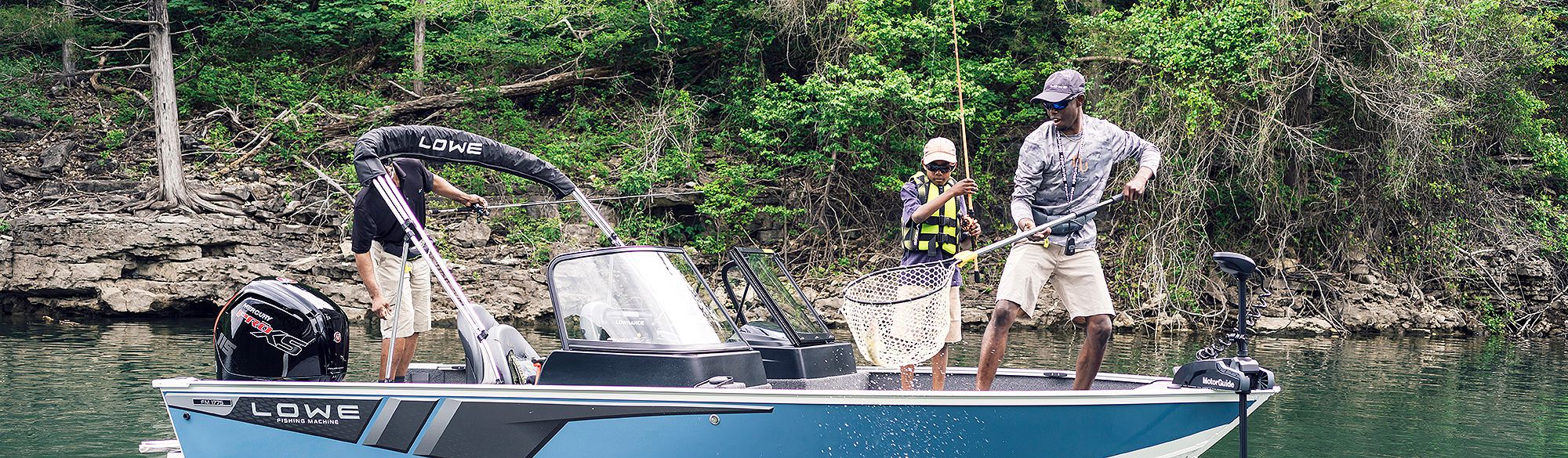 Father and son standing up, fishing on Lowe FM 1775, Starboard view